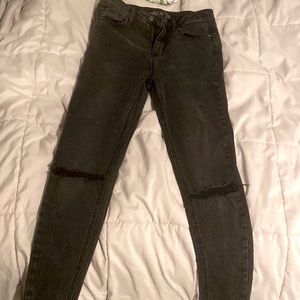 Black wash jeans with distress in the knees